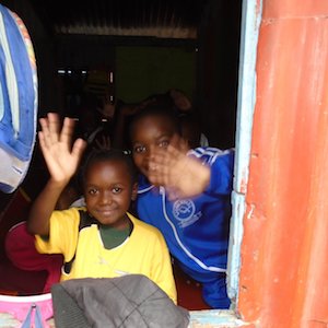Children welcome volunteers to Excel Emmanuel School